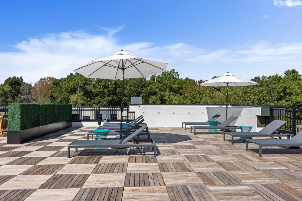 The Beacon rooftop area with lounge chairs and umbrellas