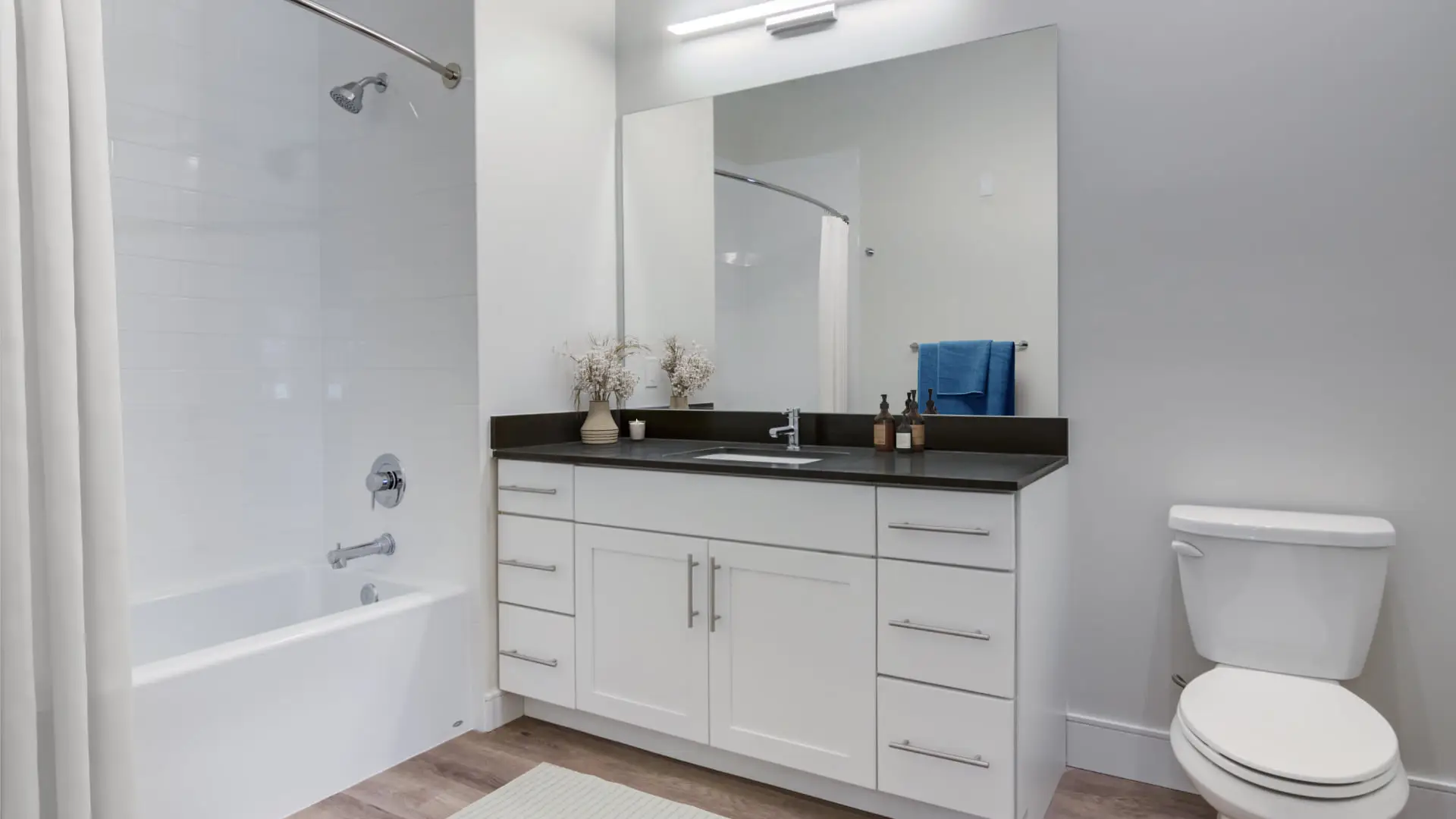 The Beacon apartment bathroom with tub and vanity - Norwalk, CT